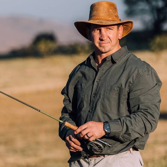 Kwagga Smith outdoors with a fly-fishing rod